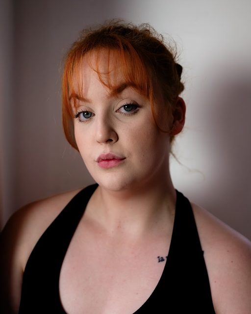 Professional headshot of Jess Latham, dramatic lighting
